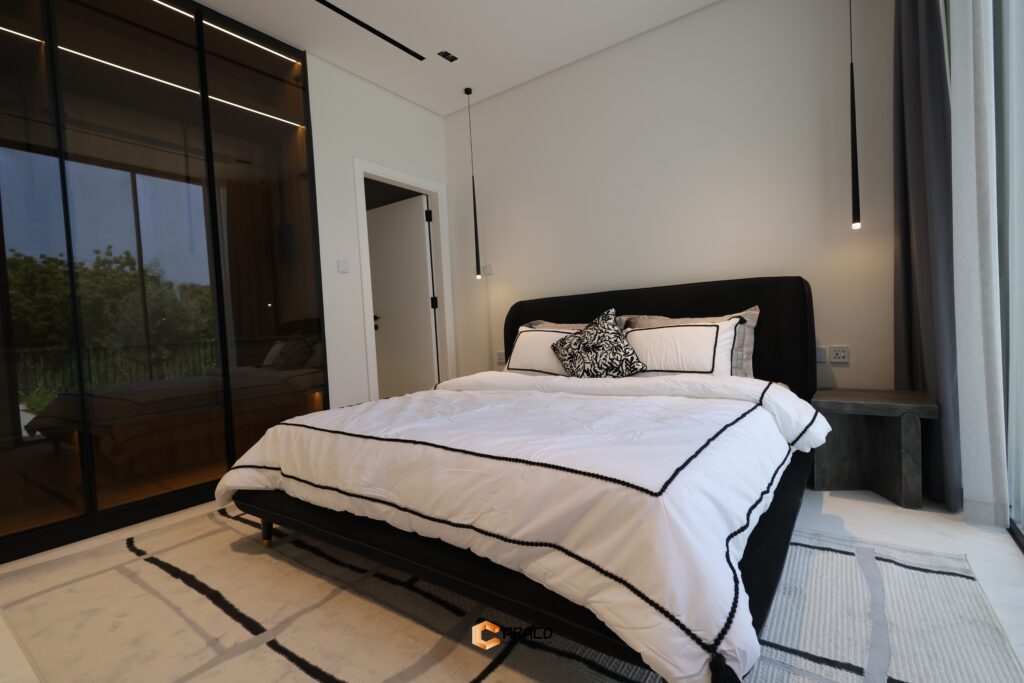 Spacious bedroom with elegant design and natural light | Caraco Building Contracting